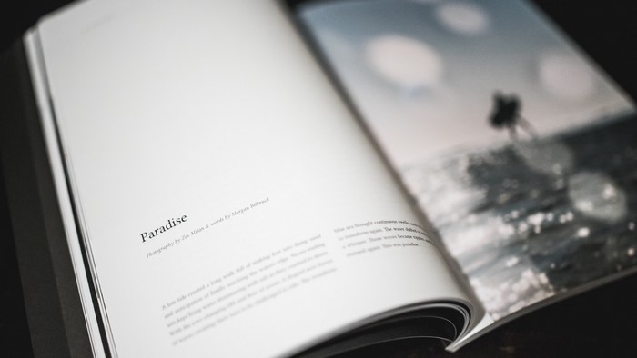 Book with "Paradise" title and ocean photograph