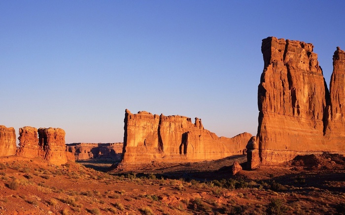 Desert landscape with sandstone rock formations at sunset