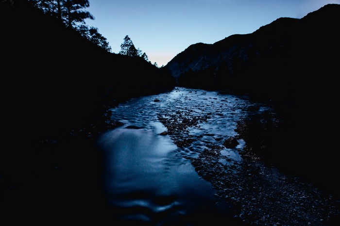 River flowing through mountains at dusk