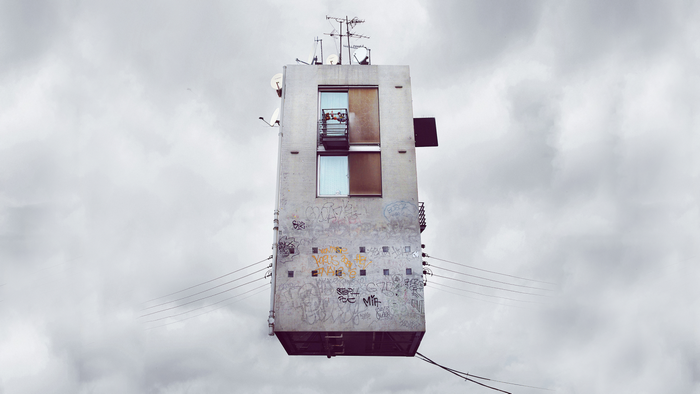 Surreal floating building with graffiti and antennas