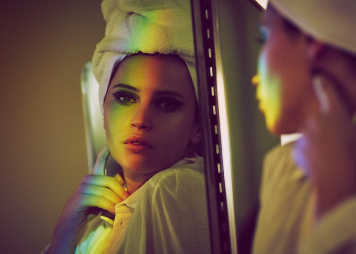Felicity Jones in a towel with rainbow light