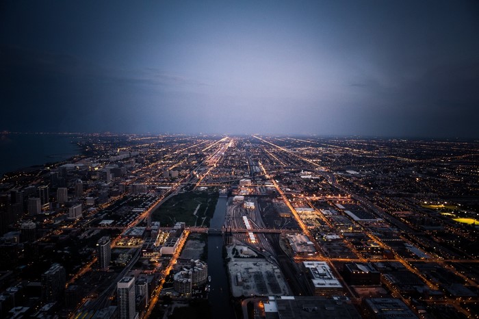 Aerial view of Chicago cityscape at dusk with lights