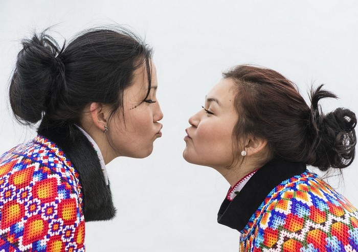 Two Women in Traditional Greenland Clothing Facing Each Other
