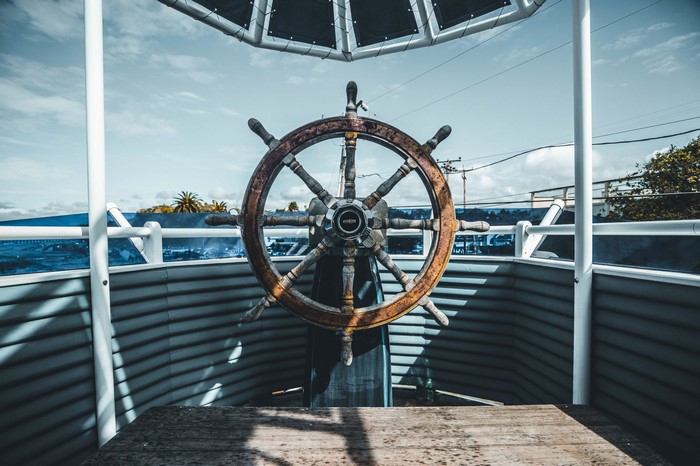 Ship's wheel on a boat deck