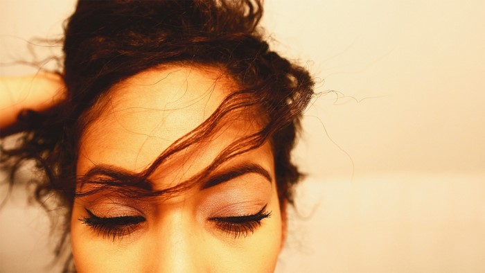 Close up of a woman's face with eyes closed