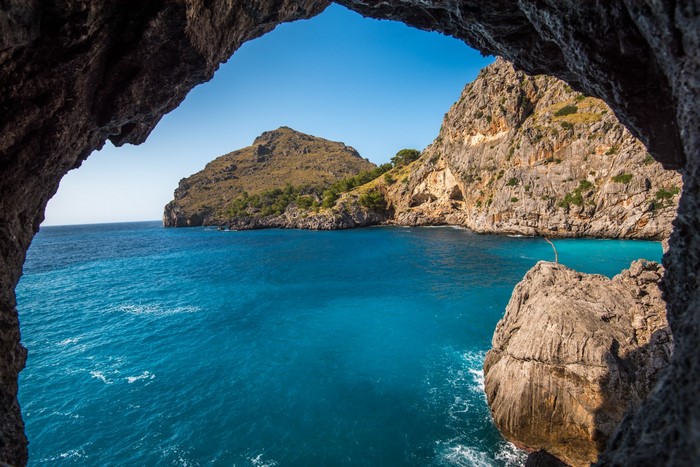 Serene Blue Cove Framed by Rocky Cave