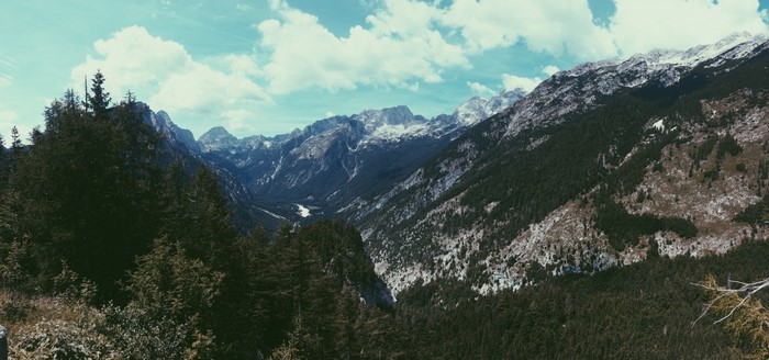 Panoramic view of a mountain valley with snow-capped peaks