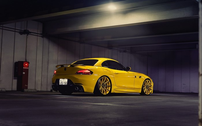 Yellow BMW Z4 sports car in a parking garage