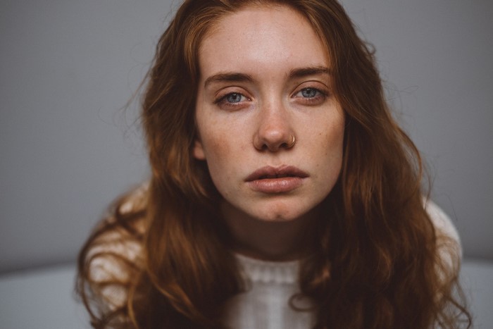 Woman with red hair and blue eyes looking at viewer