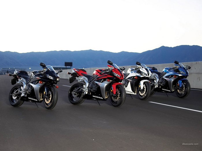 Four Honda CBR sport motorcycles lined up on a road