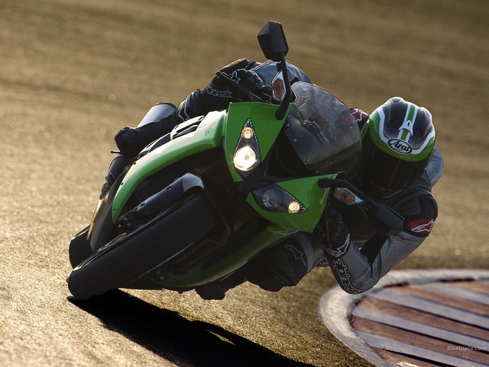 Green Kawasaki motorcycle on a race track