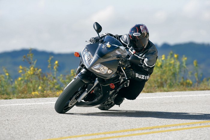 Suzuki motorcycle rider leaning into a turn