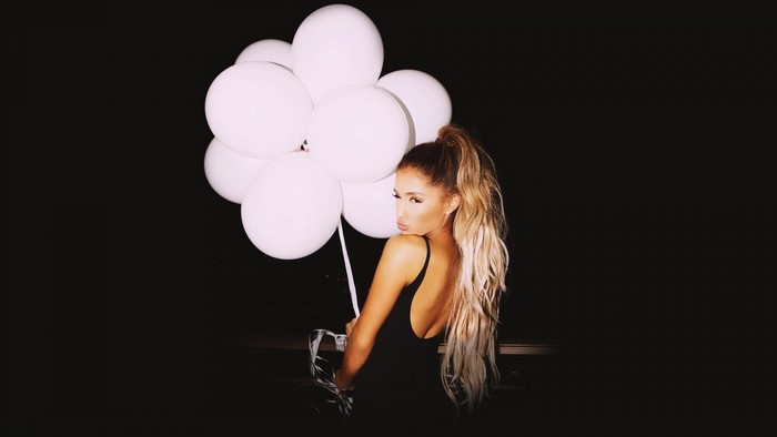 Ariana Grande holding white balloons