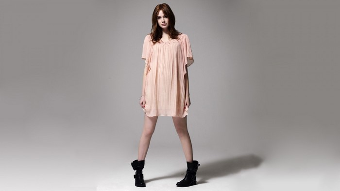 Karen Gillan in a pink dress and black boots