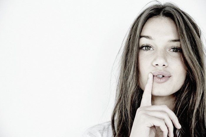Woman with finger on lips