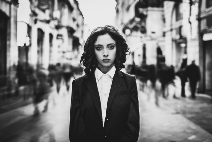Woman in suit standing on a street