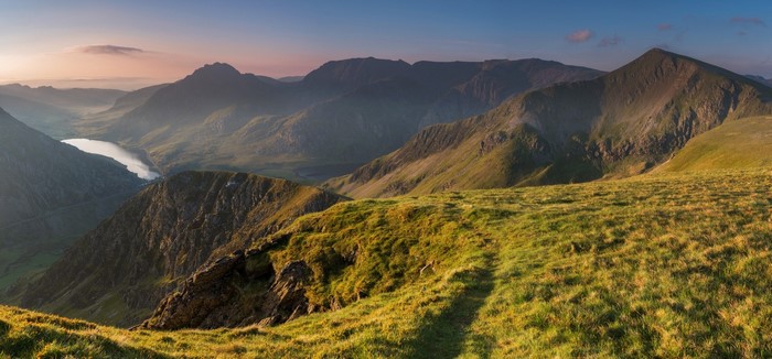 Mountain valley with lake at sunrise