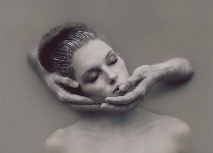 Woman's face held by hands