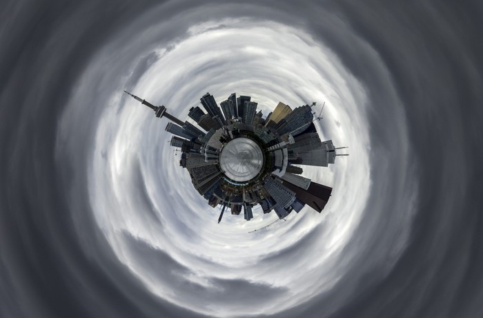 Tiny planet cityscape with swirling clouds
