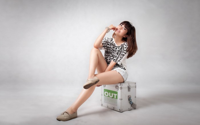 Asian woman sitting on a box