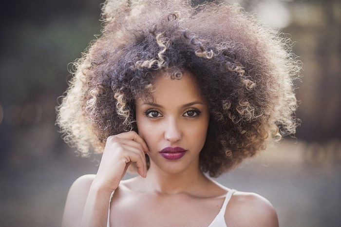 Woman with large afro hairstyle looking at viewer