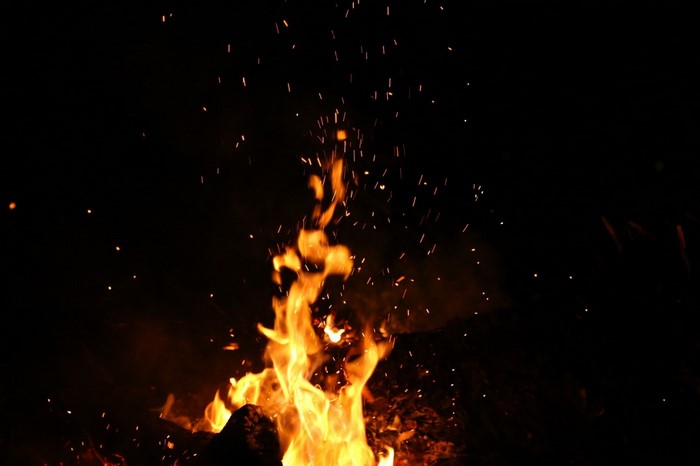 Burning campfire with sparks at night
