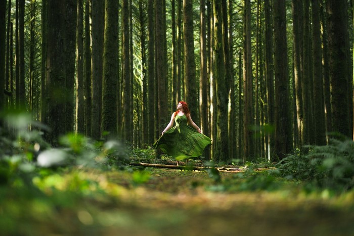 Woman in green dress in a forest