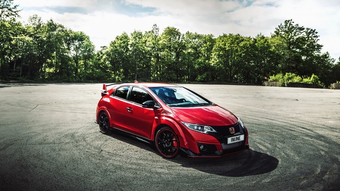 Red Honda Civic Type R parked on asphalt