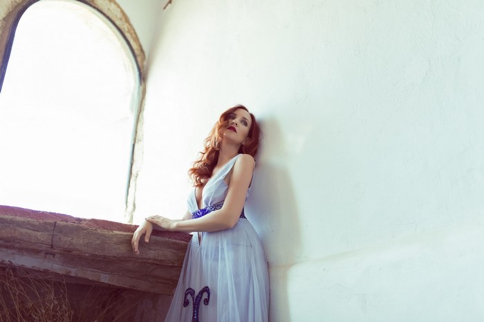 Woman with red hair in a light blue dress
