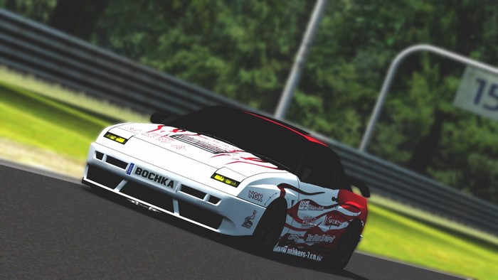 White and red sports car on a race track