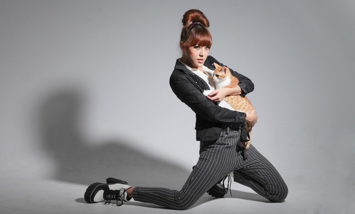 Woman in fashion posing with a cat