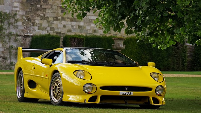 Yellow Jaguar XJ220S sports car on grass