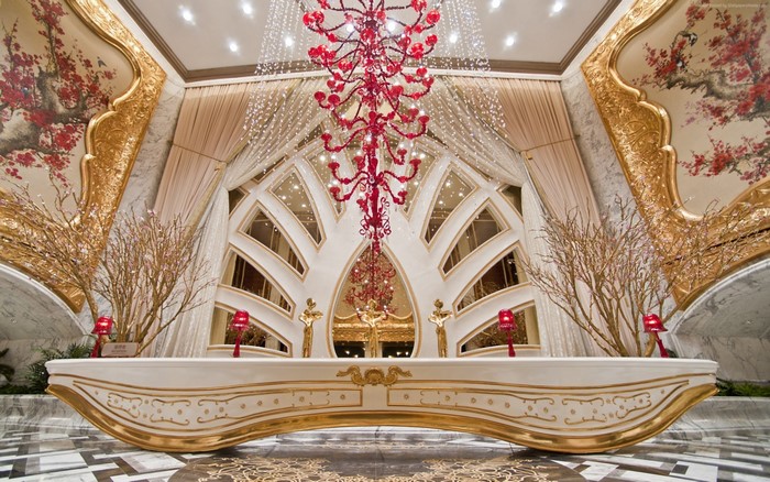 Luxurious hotel lobby with ornate chandelier and artwork