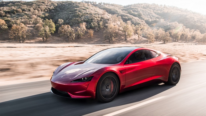 4K Tesla Roadster electric car driving on a road