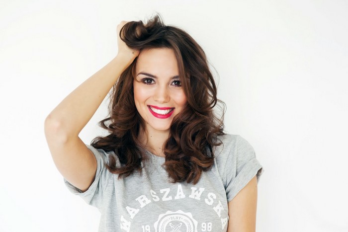 Woman with hand in hair wearing a t-shirt