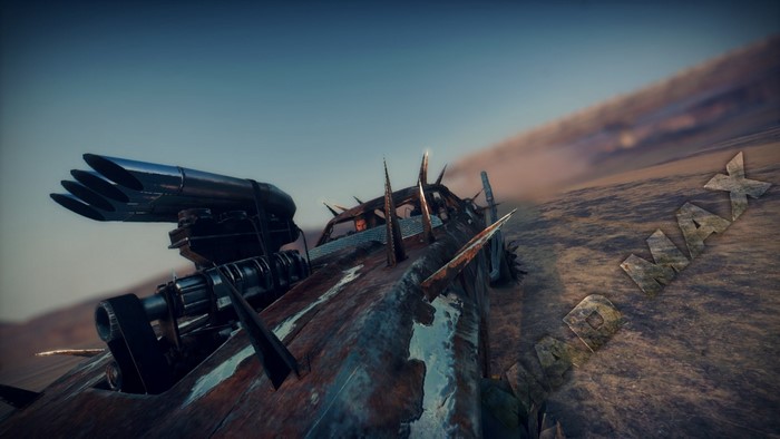Mad Max game screenshot of a spiked vehicle in the desert
