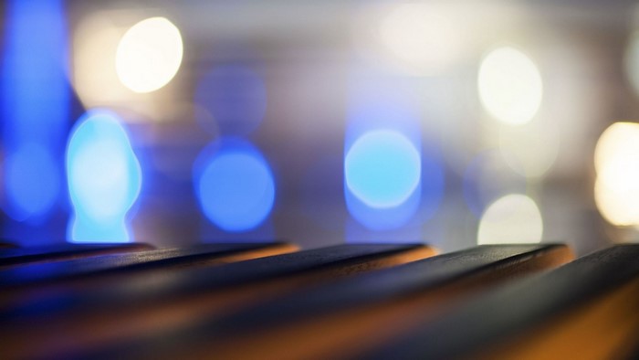 Blurred blue and white bokeh lights over dark surface