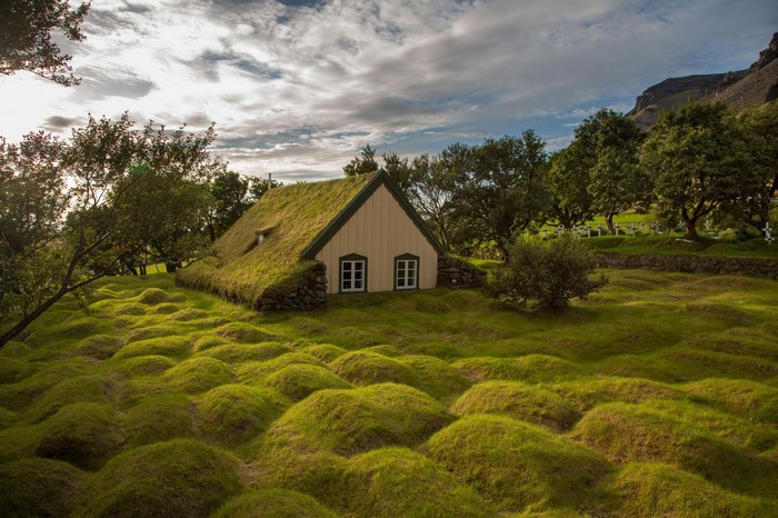 Grass-roofed house in a hilly landscape in Iceland