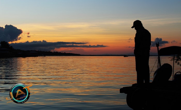 Silhouette of a man on a boat at sunset in Bocas del Toro