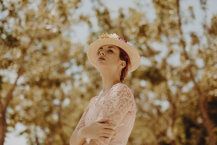 Woman in a straw hat and lace dress outdoors