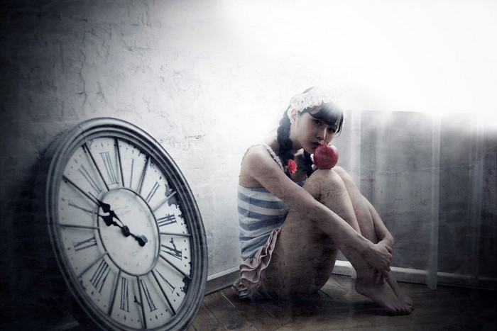 Contemplative Woman Sitting Near Large Clock