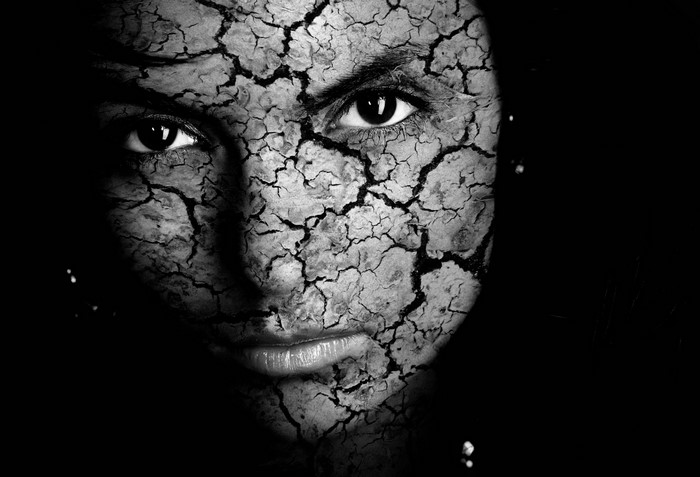Close up of a woman's face with cracked texture