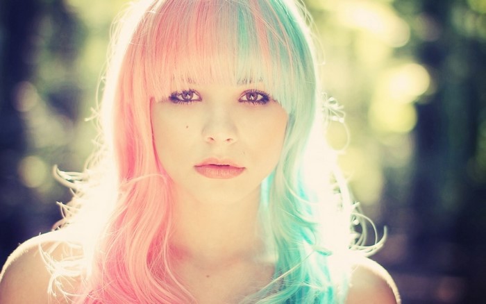 Woman with split pink and teal hair