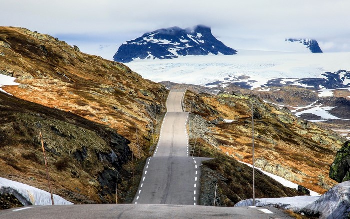 Mountain road leading to a glacier and mountain peak