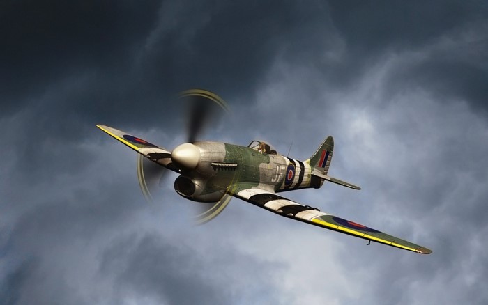 Supermarine Spitfire fighter aircraft in clouds