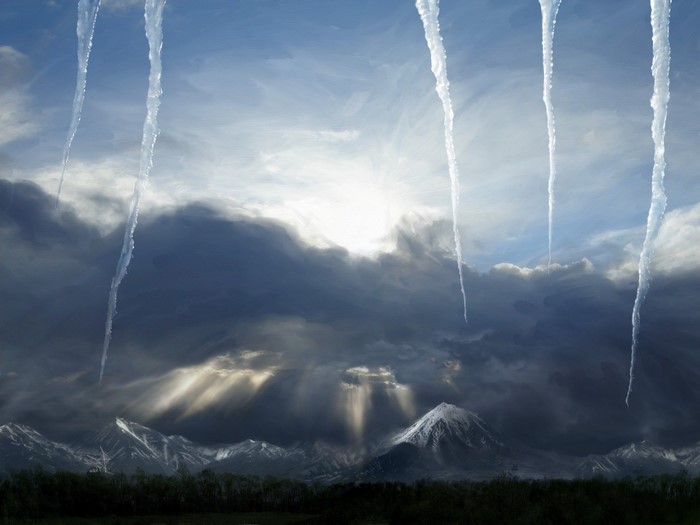 Icicles hanging in front of stormy mountain landscape with sunbeams