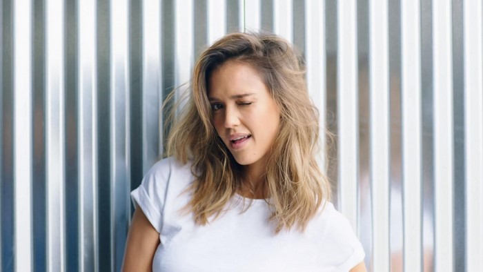 Jessica Alba winks in a white t-shirt
