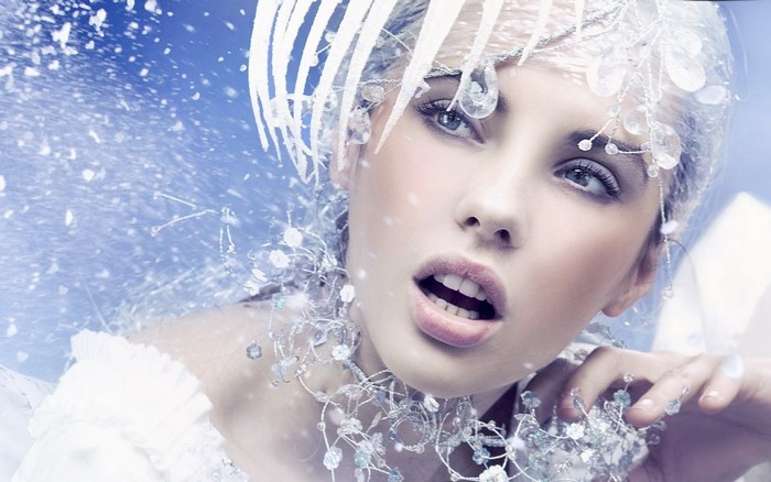 Woman with ice-like accessories and snowflakes