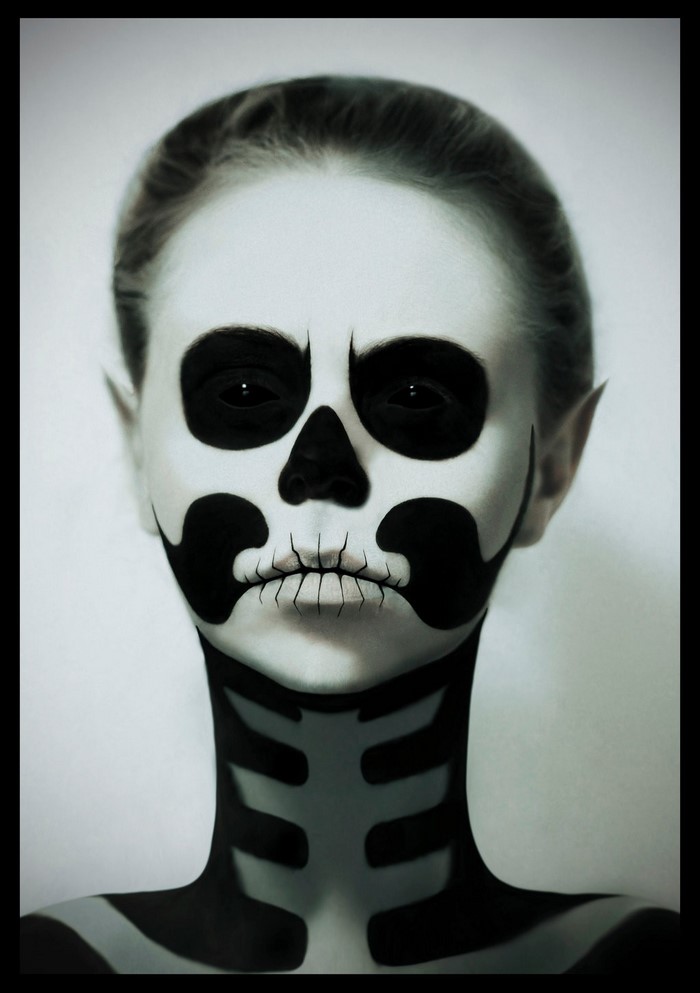 Person with skeleton face paint and costume