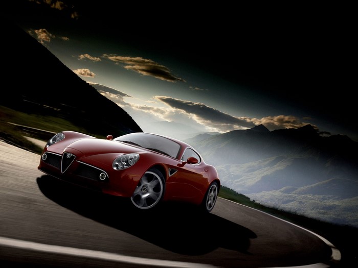 Red Alfa Romeo Sports Car on a Mountain Road